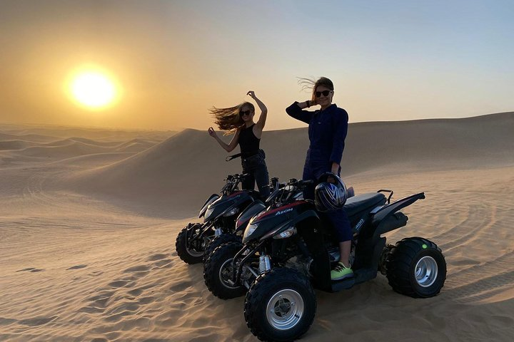 Experience the vast desert landscape on a private quad bike tour riding at your own pace while enjoying stunning views and the possibility of encountering camels along the way.